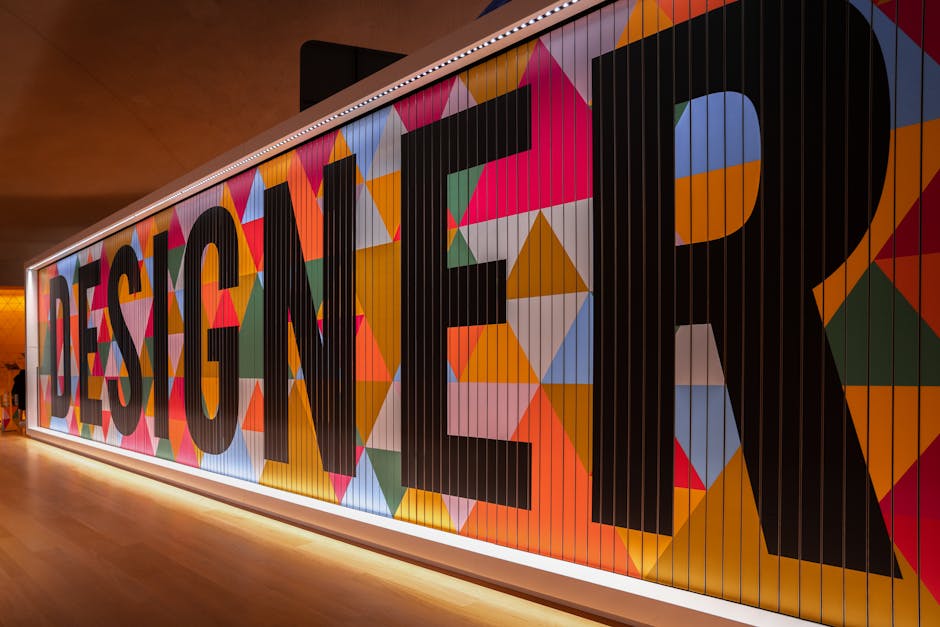 Vibrant geometric design with 'DESIGNER' text in London gallery.